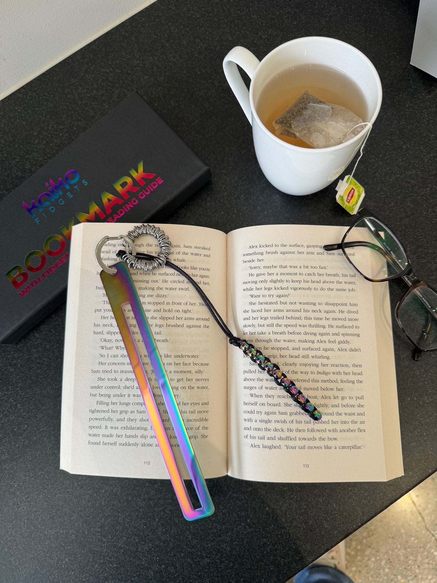 Kaiko Fidgets metal bookmark in oil slick finish with reading guide pane and fidget hook for sensory focus aid - view 16