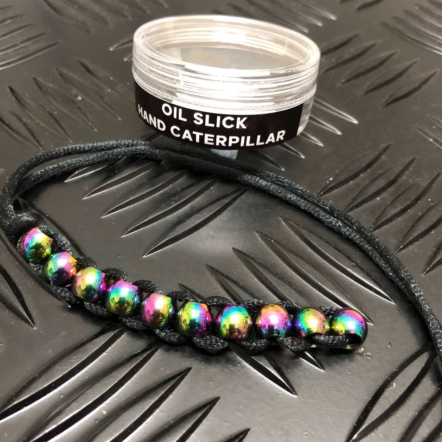 Kaiko Hand Caterpillar Fidget in Oil Slick finish showing colourful chain links for sensory focus and regulation
